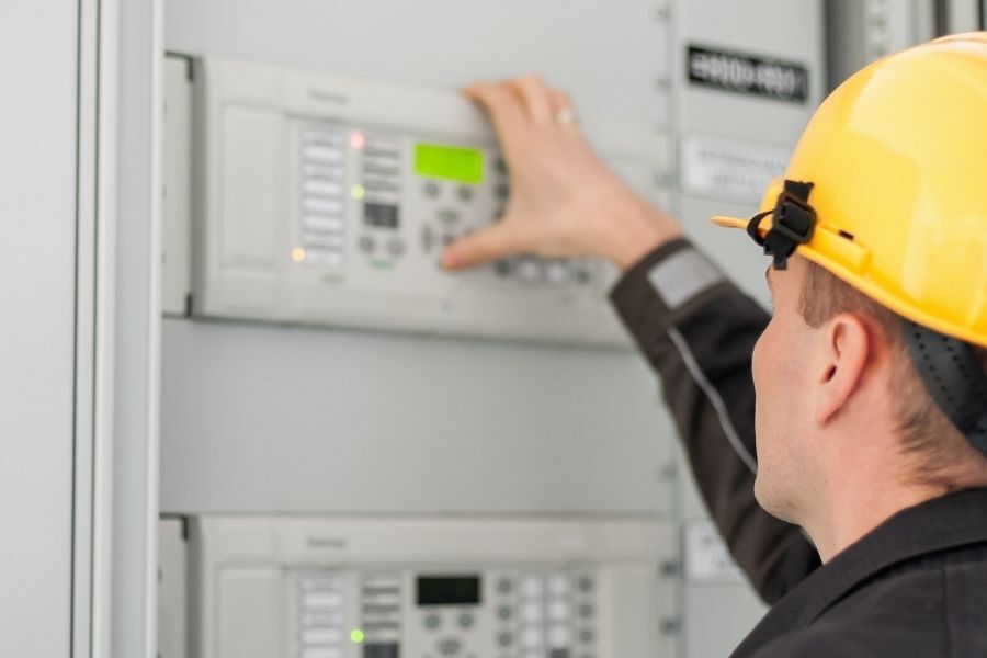 A technician running UPS preventive maintenance procedure in their facility.