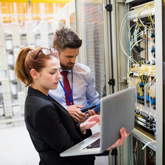 a man and a woman working to repair a mission critical ups system