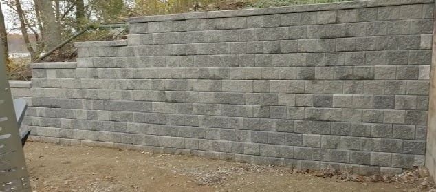Block retaining wall installation with interlocking concrete units, completed in Atlanta