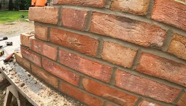 bricklaying with new red clay brick wall, completed in Atlanta