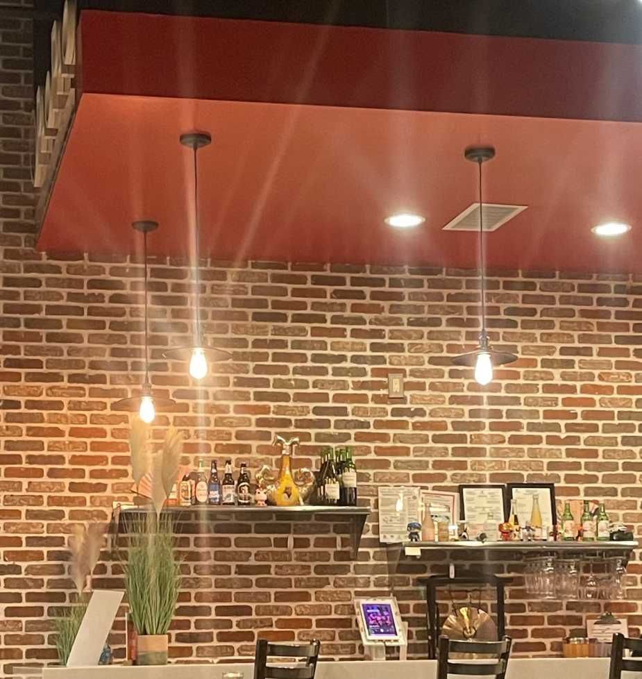 Metro Atlanta brick mason installs interior feature brick accent wall behind cash registers inside commercial restaurant