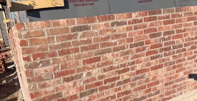 Brick wall construction with running-bond brick pattern, completed in Atlanta