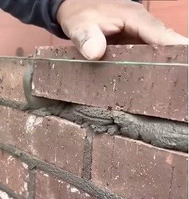 Brick wall repair with color-matched red brick, completed in Atlanta
