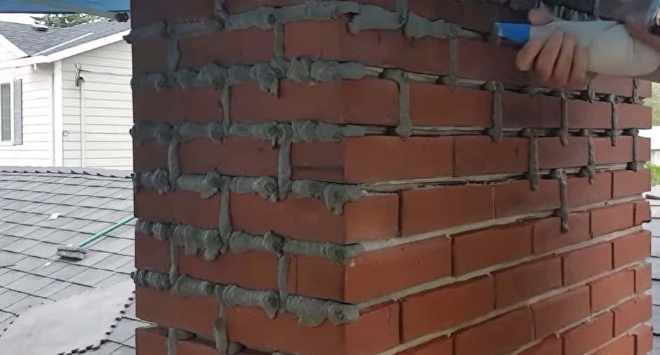 Brick chimney repair with matching brick and mortar, completed in Atlanta