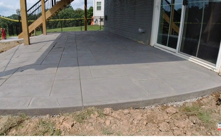 Metro Atlanta concrete contractor installs covered patio at basement level beneath main floor deck on residential home