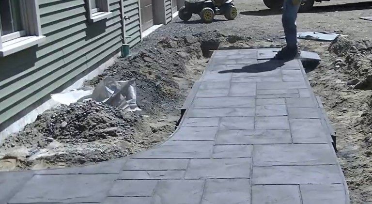 Metro Atlanta concrete contractor installs stamped concrete paver walkway outside residential home