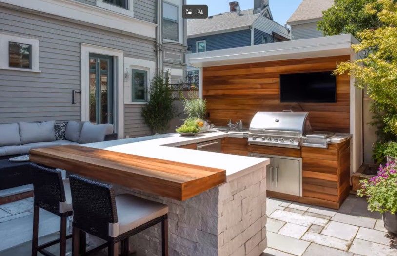 Metro Atlanta hardscaping contractor builds outdoor kitchen with stone paver flooring, built-in grill, and stone bar area