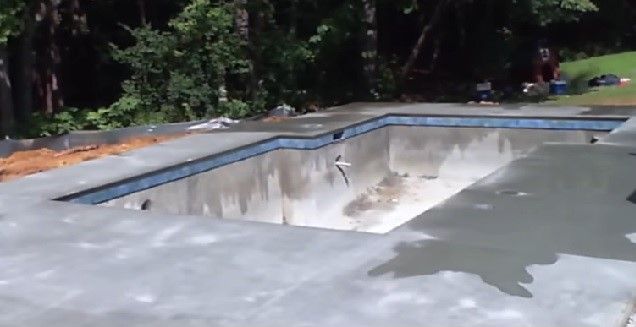 Swimming pool in-ground installation with tiled pool coping, completed in Atlanta