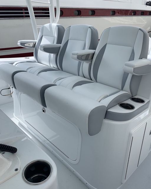 A boat with a couch and a cup holder on it.