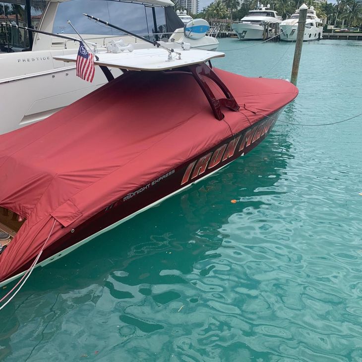 A boat with a red cover on it is in the water