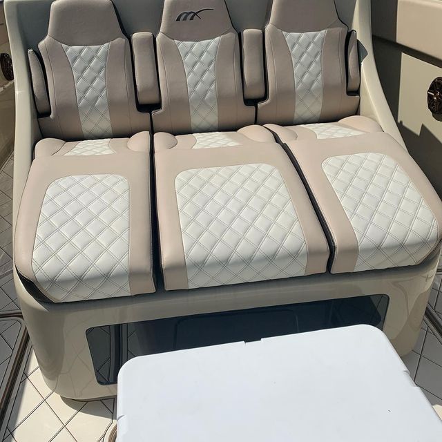 A boat with a couch and cooler on the deck