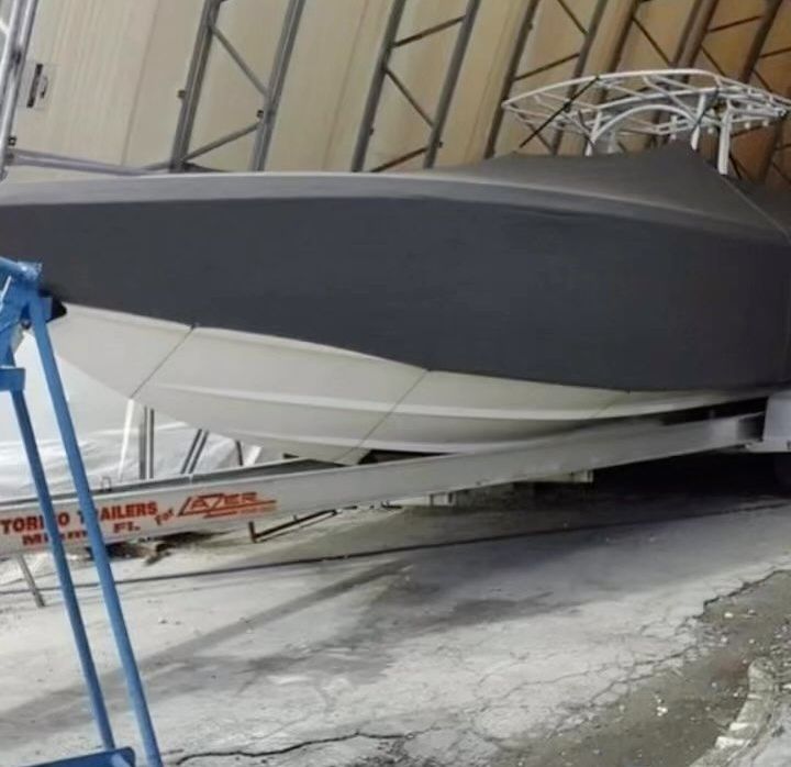 A boat is sitting on a trailer that says toro trailers