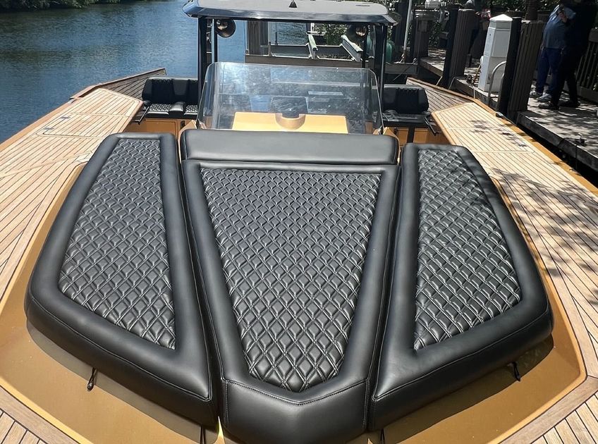 The back of a boat with a cushion on it