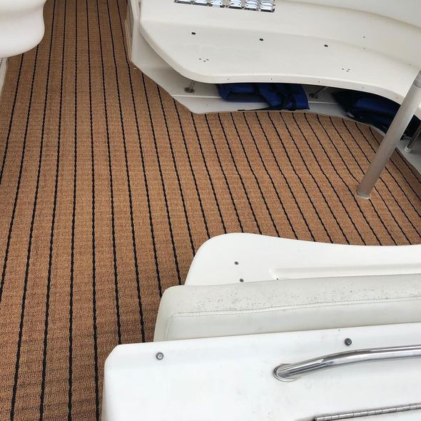 A boat with a brown and black striped floor