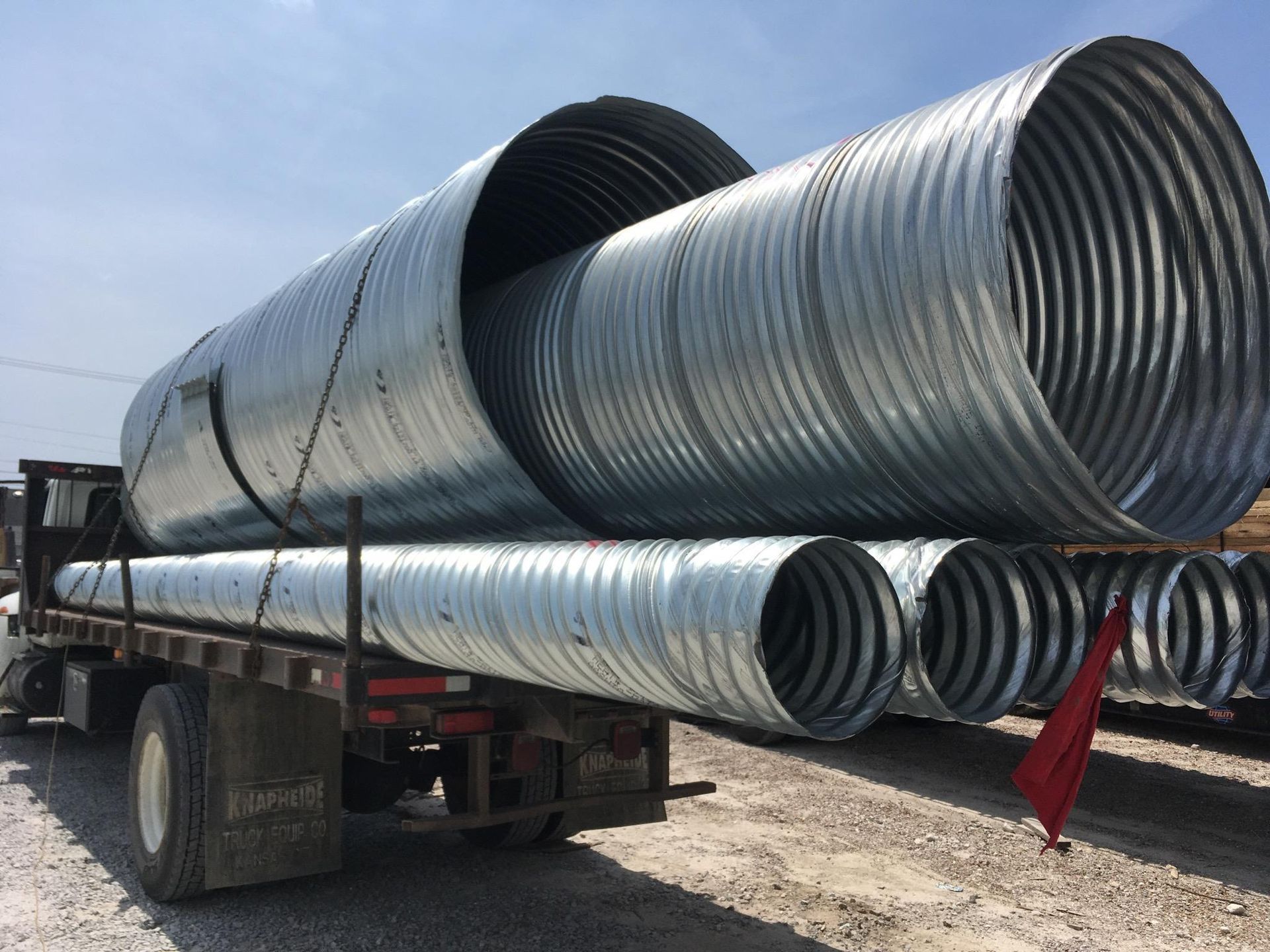 A truck is carrying a bunch of metal pipes — Odessa, MO — Continental Pipe Co.
