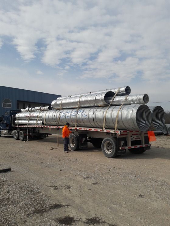 A truck is carrying a stack of metal pipes on a trailer — Odessa, MO — Continental Pipe Co.