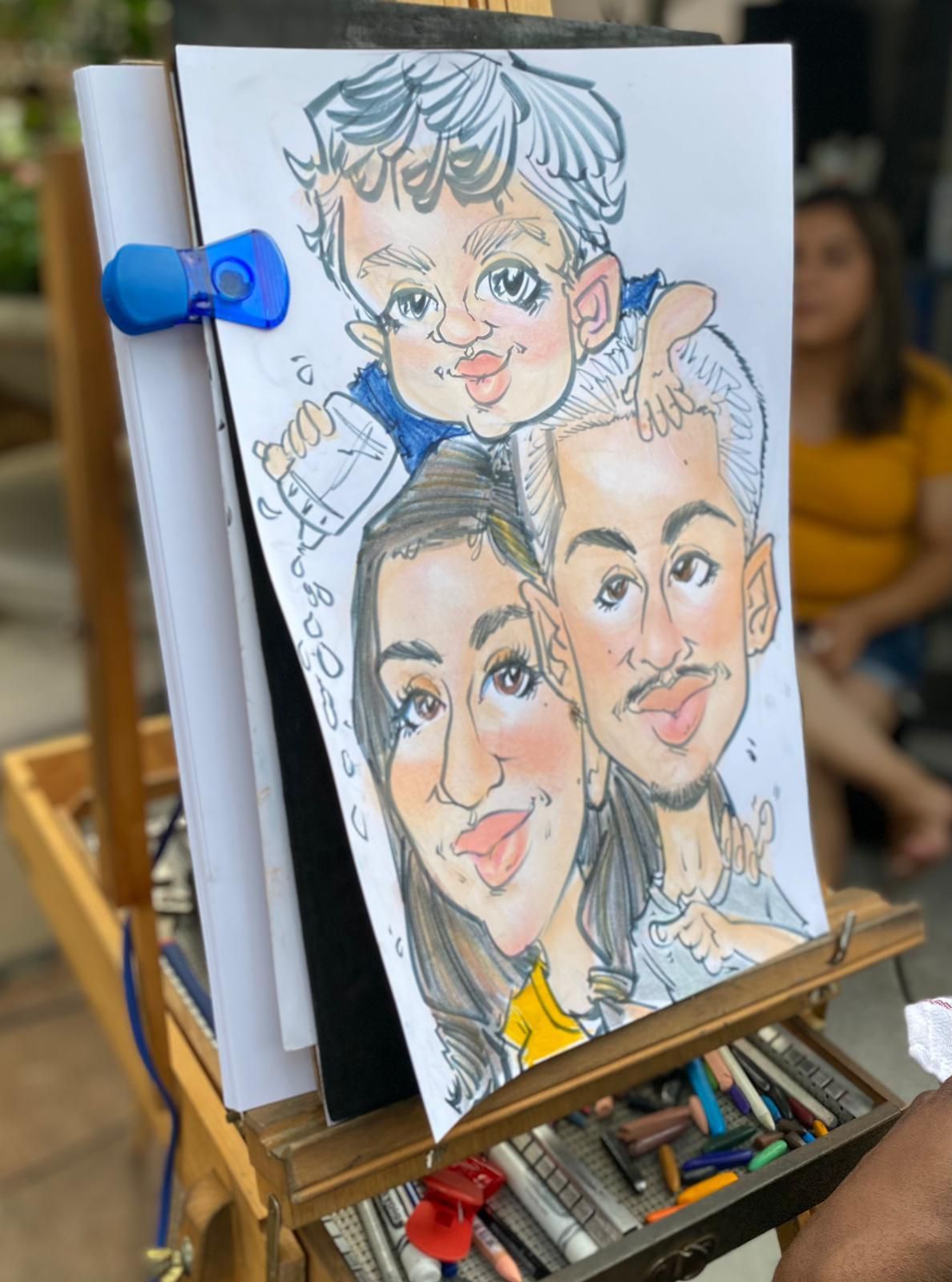 A caricature of a family is on an easel