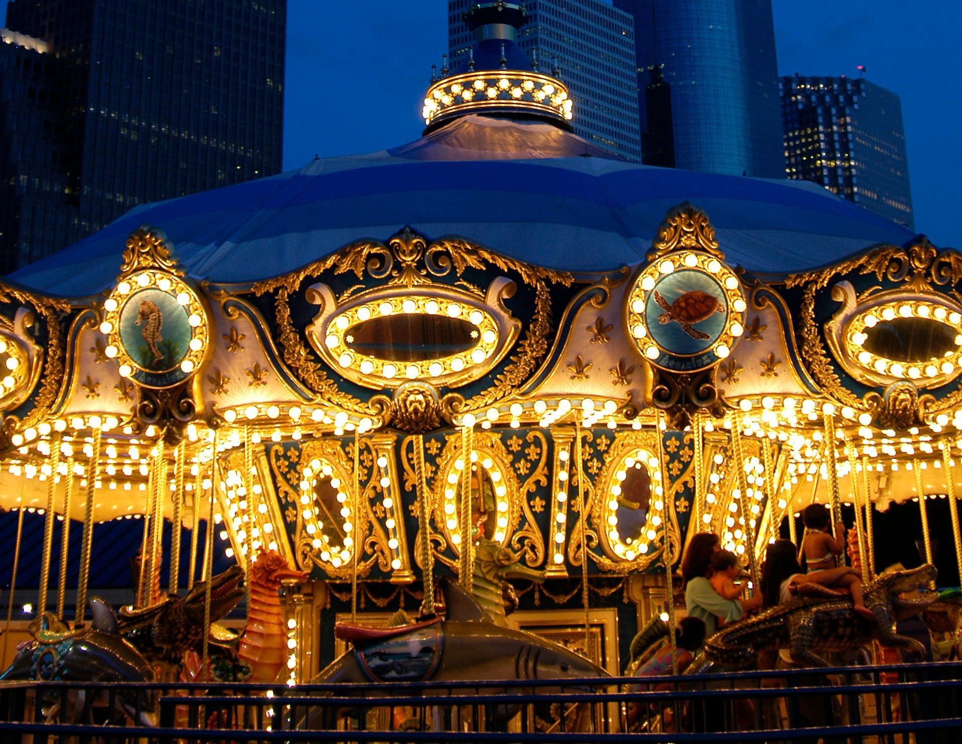 A merry go round that has the word carousel on it