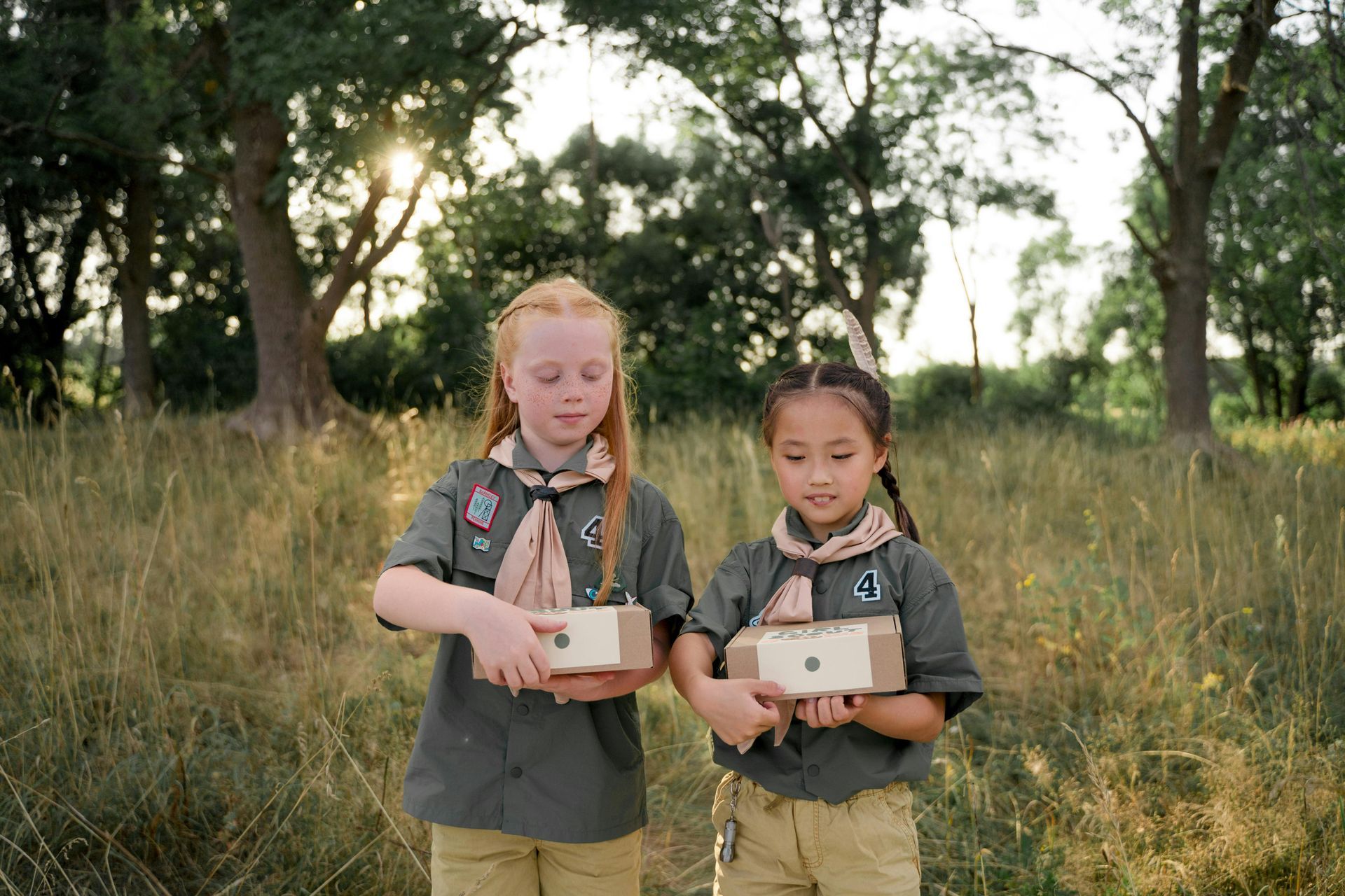 Two boy scouts are posing for a picture with one wearing a watch