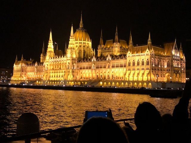 Intimate river cruise ship on European river at golden hour