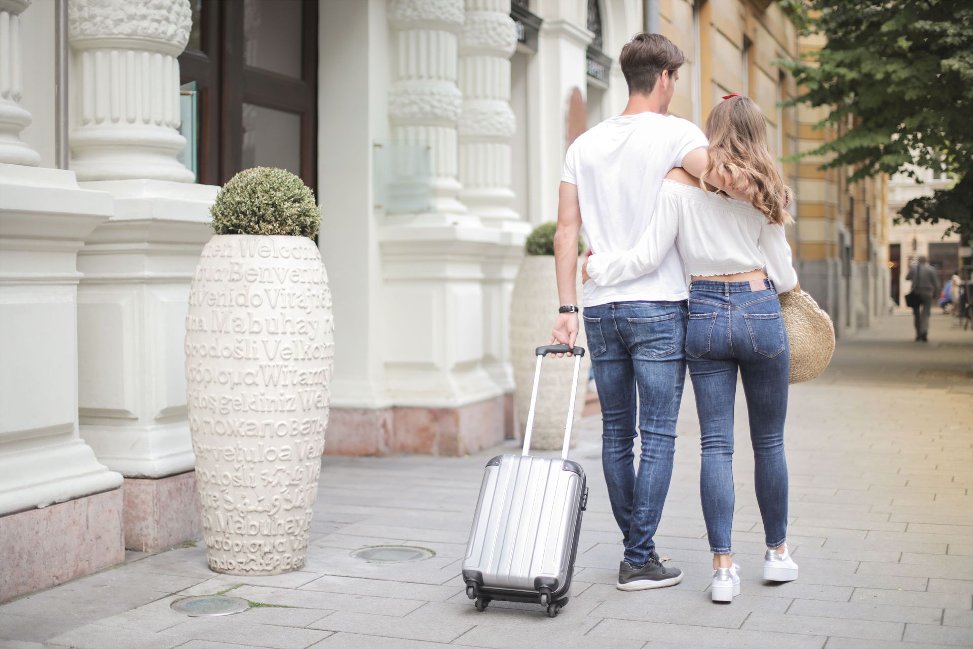 Couple reviewing travel insurance documents at kitchen table