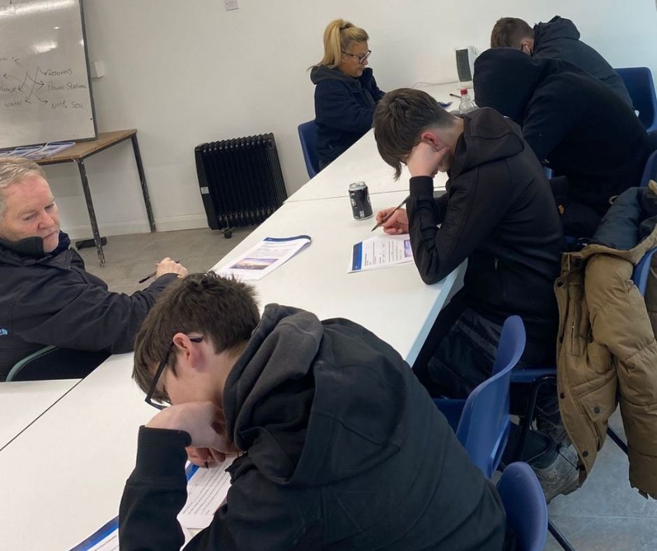 A few students are taking the CSCS health and safety test at Chameleon Skills.