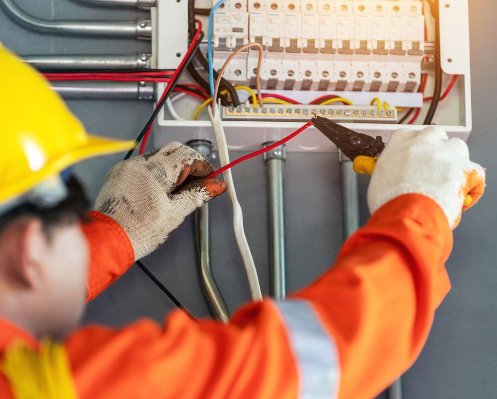 Electrician Working On Wires — Fort Lauderdale, FL — Langer Electric Service Co.