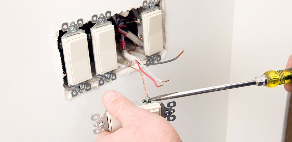 Installing New Light Switches — Fort Lauderdale, FL — Langer Electric Service Co. Installing New Light Switches — Fort Lauderdale, FL — Langer Electric Service Co.