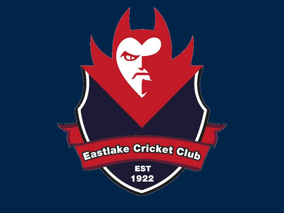 Eastlake Cricket Club logo with red and navy shield, stylized face, and “EST 1922” text