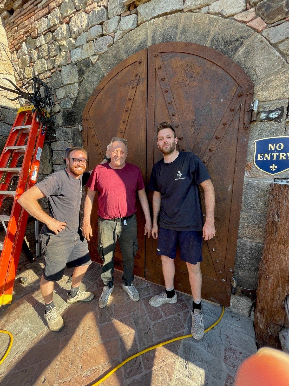Italian craftsmen installing the tasting room doors.