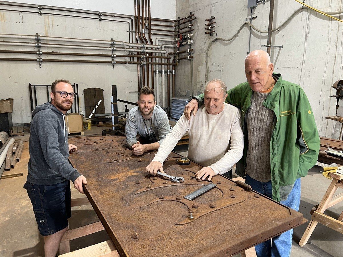 Dario Sattui with Italian craftsmen working on farmhouse doors.