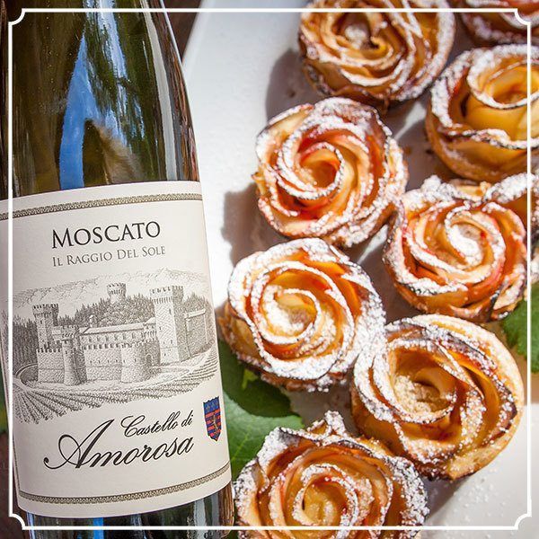 Bottle of Castello di Amorosa Moscato with apple rose pastries dusted with powdered sugar.