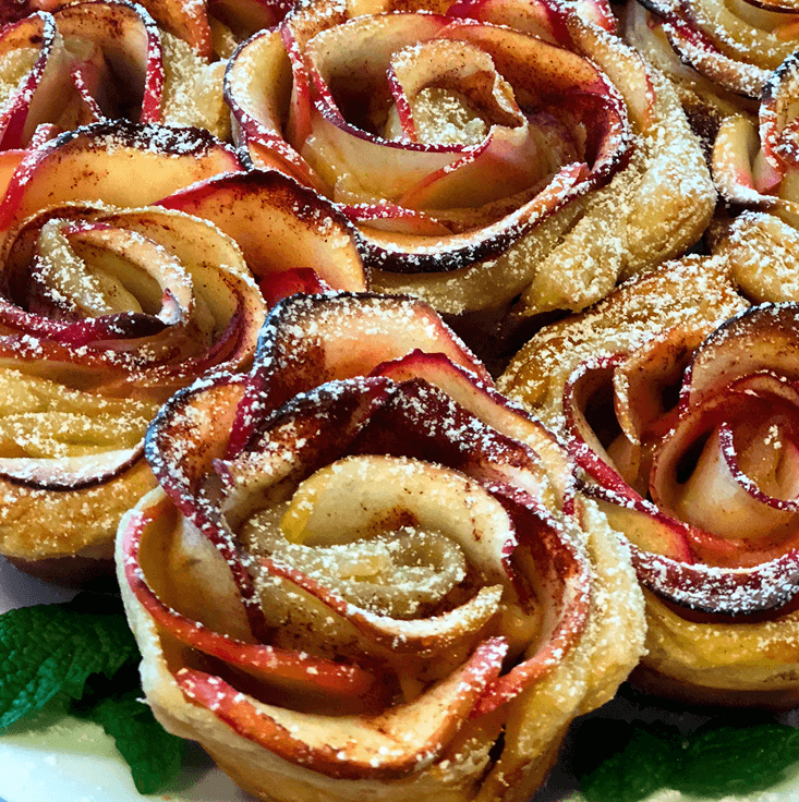Apple roses, baked pastry, powdered sugar dusted.