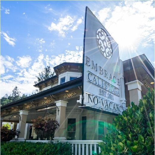 Sign for Embrace Calistoga hotel; sunny exterior view.