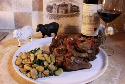 Braised lamb shanks served with beans and wine