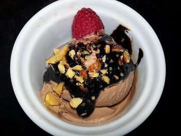 Chocolate dessert with sauce and nuts.