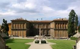 a large building with a lawn and trees in front of it with Palazzo Pitti in the background