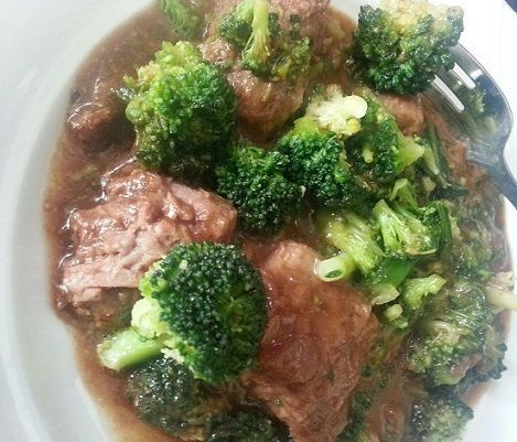 Beef and broccoli dish served on a white plate