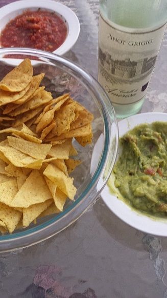 Guacamole with tortilla chips served on a plate