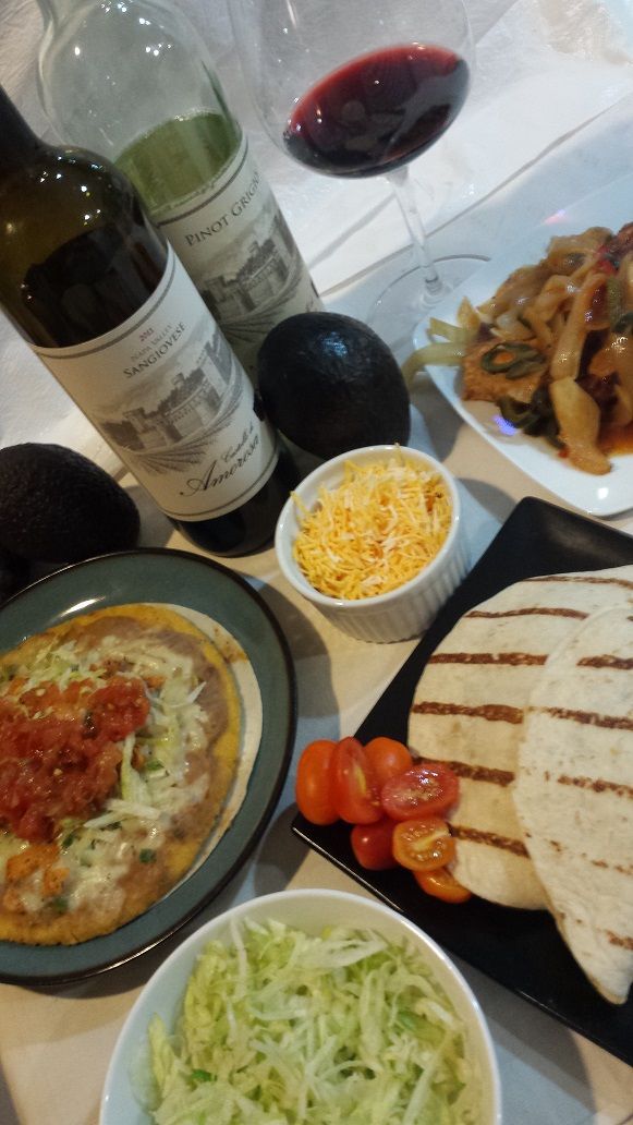 Mexican dishes with tacos, chips, and salsa on a table
