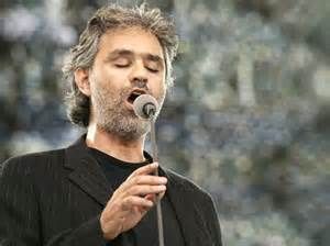 Man singing into microphone outdoors