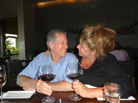 Couple sharing wine and smiling at each other
