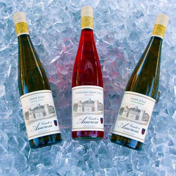 Three wine bottles on ice: two white, one rosé, labeled 