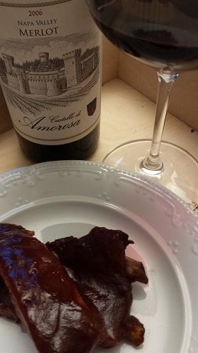 BBQ ribs with a glass of red wine and bottle of Merlot