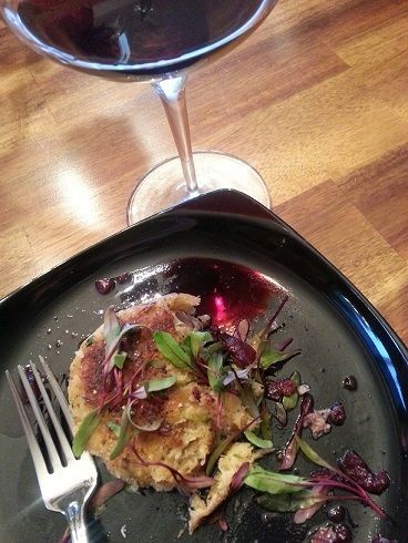 Crab cake dish with wine on a wooden table
