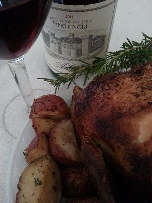 Roasted chicken with potatoes served with red wine