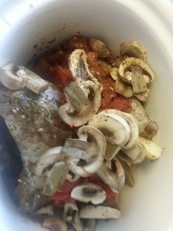 Slow cooker with lamb shanks, mushrooms, and sauce