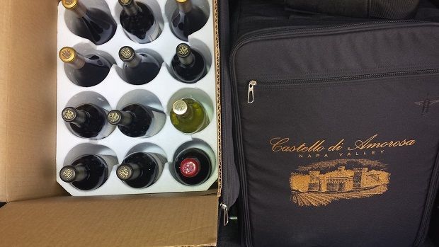 Wine transport case with bottles and branded travel bag