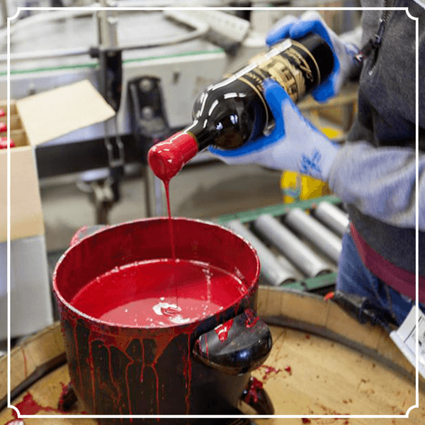 Bottle being dipped in wax