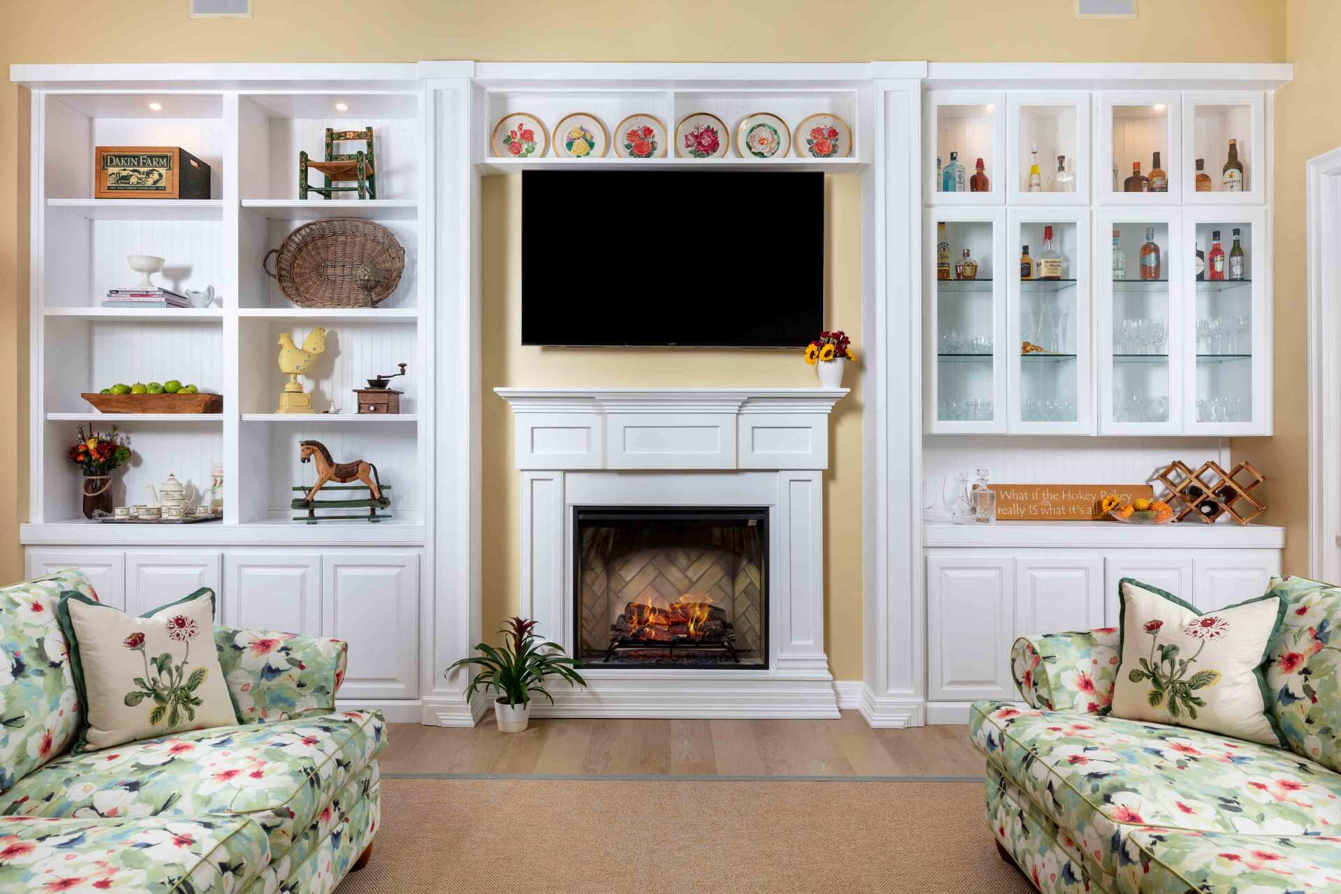 A living room with a fireplace and a flat screen tv.